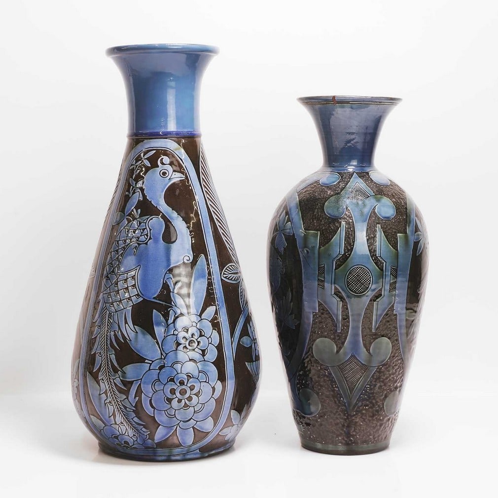 C H Brannam Pottery Two vases: C H Brannam Pottery Two vases A vase, dated 1885, by William Baron, with a slip glaze of brown and blue, incised with panels of birds on foliage, incised 'CH Brannam Barum, with artist's monogram 'WD'