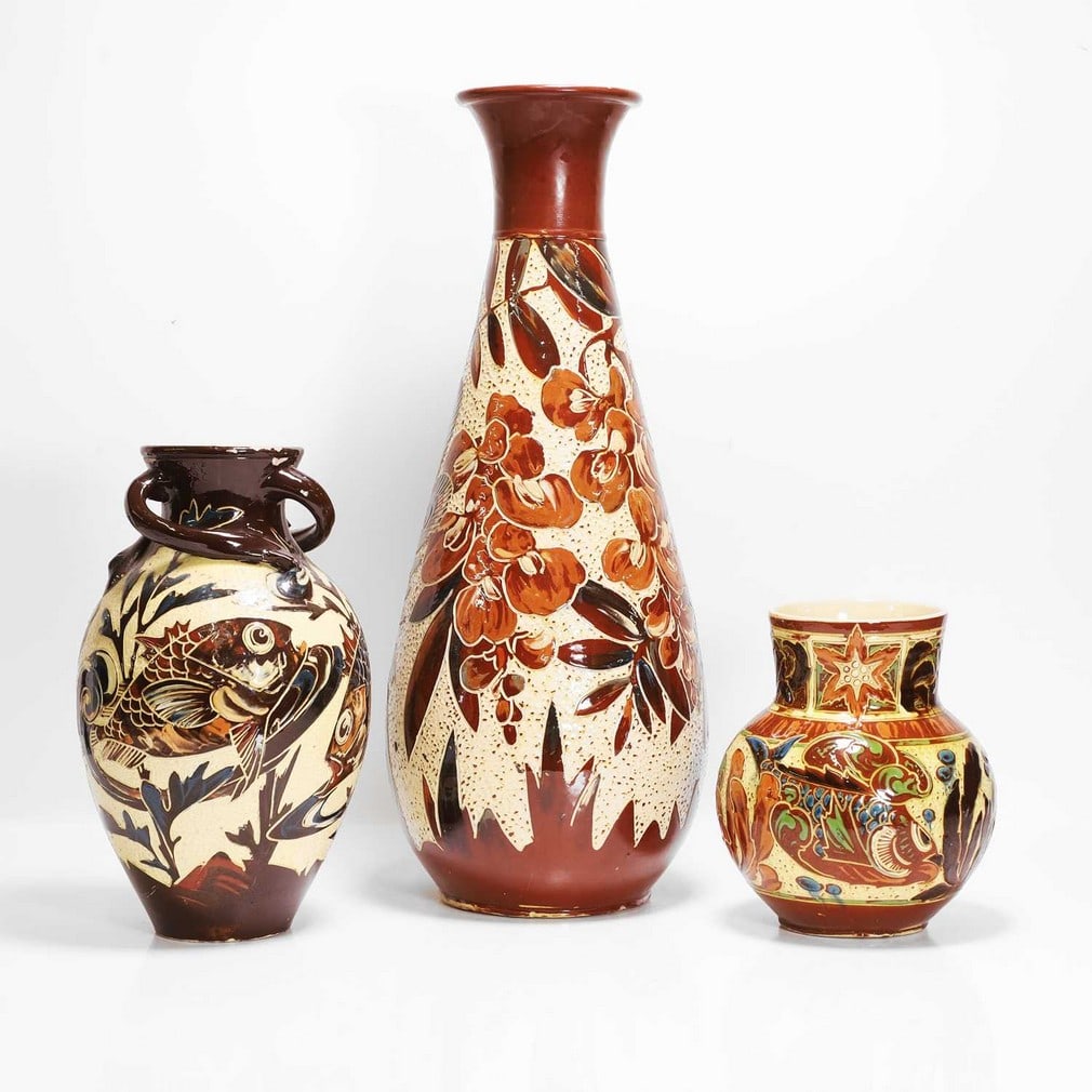 C H Brannam Pottery Three vases: C H Brannam Pottery Three vases Comprising a vase, dated 1893, by James Dewdney, of tapering form with a slip glaze, incised with a peacock and wisteria, on a cream rusticated ground, incised marks an