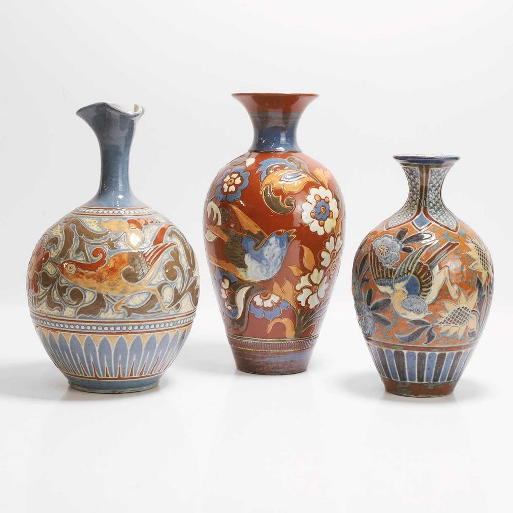 C H Brannam Pottery Three vases: C H Brannam Pottery Three vases Comprising: a vase, dated 1888, by James Dewdney, incised with a band of birds amongst flowers, incised 'CH Brannam Barum', with artist's monogram 'JD'; a vase, dated 1