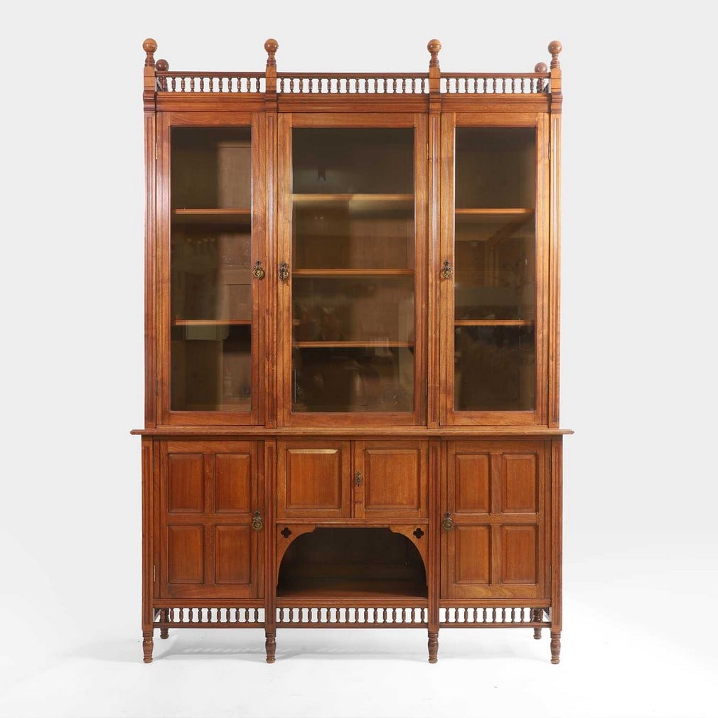 Gillows of Lancaster A late Victorian mahogany display cabinet: Gillows of Lancaster A late Victorian mahogany display cabinet Late 19th century, the glazed top with three doors and shelving inside, over a panelled base with cupboards and a central open recess fea