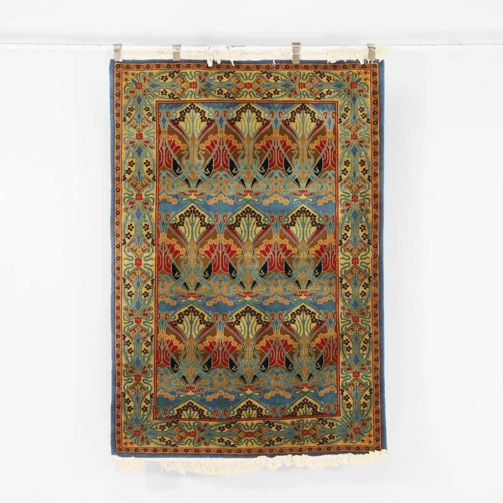 Liberty & Co. An 'Ianthe' rug: Liberty & Co. An 'Ianthe' rug Of recent manufacture, wool, retailed by Liberty & Co., the pattern originally designed in 1902 by René Beauclair for Liberty & Co. (197.5cm long x 125cm wide)