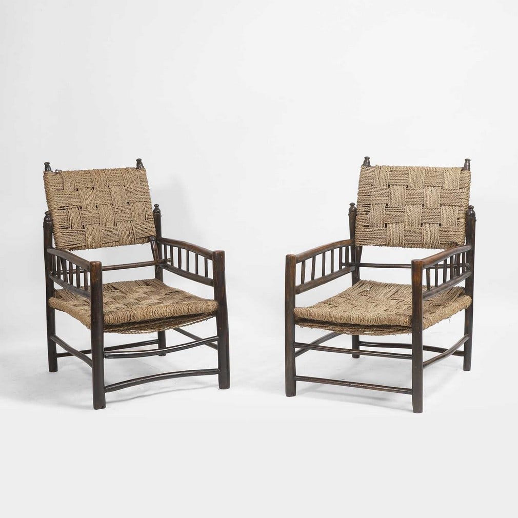 French A pair of vernacular armchairs: French A pair of vernacular armchairs Early 20th century, the oak frame with rope seats and backs (48cm wide, 61cm deep, 77cm high, seat 32cm) (2)