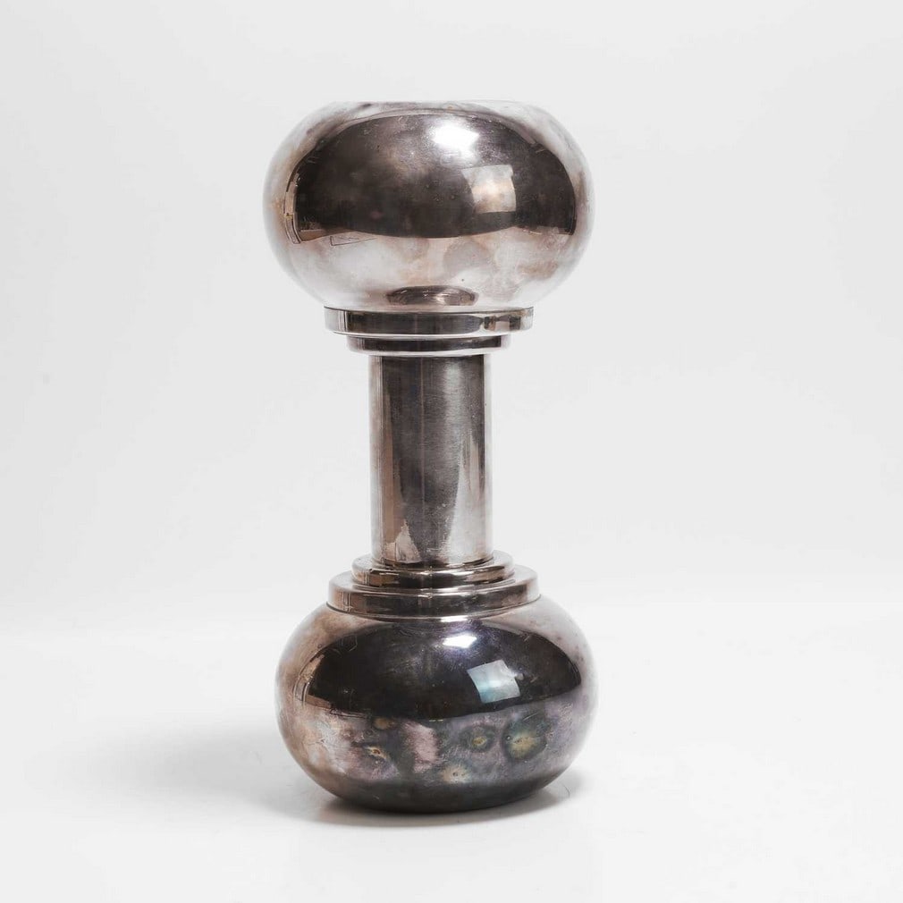 Asprey An Art Deco novelty cocktail shaker: Asprey An Art Deco novelty cocktail shaker Silver-plated, c.1930s, with an internal domed strainer, in the form of a dumbbell, stamped manufacturer's marks (12cm wide, 27cm high)