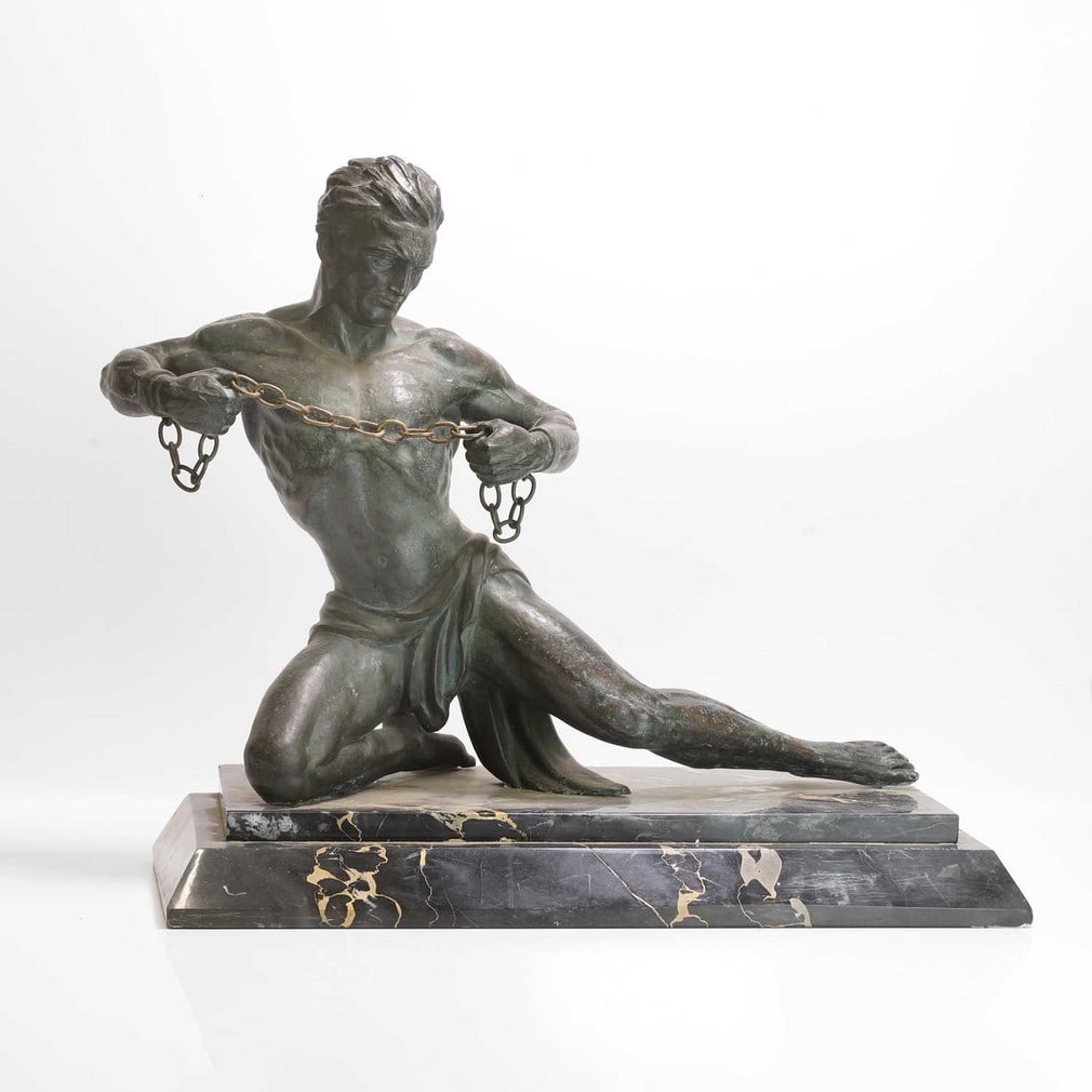After Jean de Roncourt 'Hercules breaking his Chains': After Jean de Roncourt 'Hercules breaking his Chains' An Art Deco spelter sculpture raised on a stepped marble plinth, inscribed 'J de Roncourt' (60.5cm wide, 29cm deep, 83.5cm high)