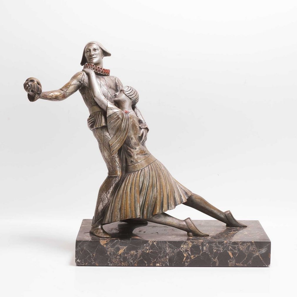 Art Deco 'The Masked Ball': Art Deco 'The Masked Ball' French, silvered bronze sculpture, signed indistinctly 'Caurines', on a veined marble plinth (41cm wide, 17.5cm deep, 37cm high) Condition Report: With rubbing to