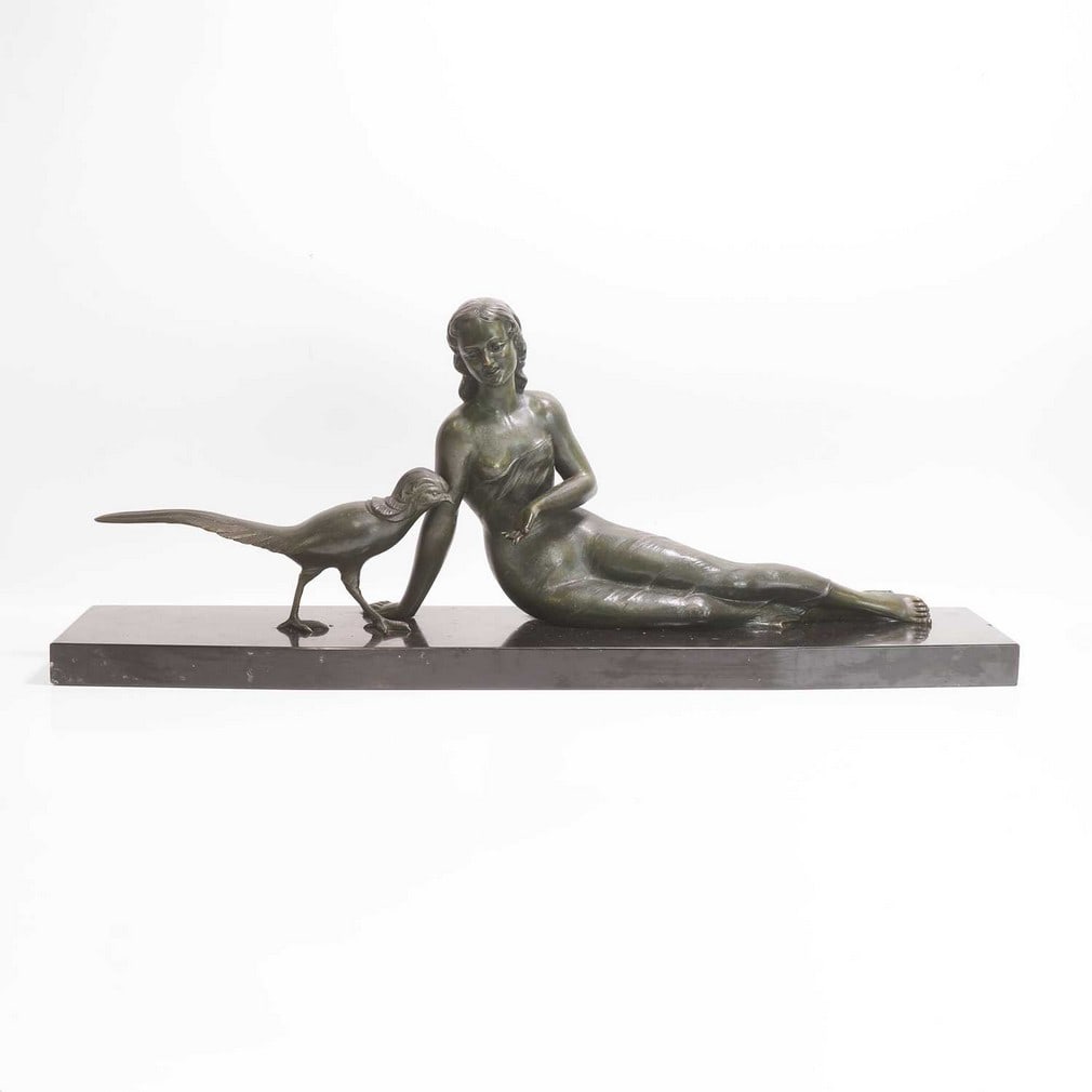 Melani (French, 20th century) A patinated bronze of a lady and a peacock: Melani (French, 20th century) A patinated bronze of a lady and a peacock Green patinated bronze, on an angular fronted marble plinth, signed (87cm wide, 21cm deep, 34.5cm high) Condition Rep