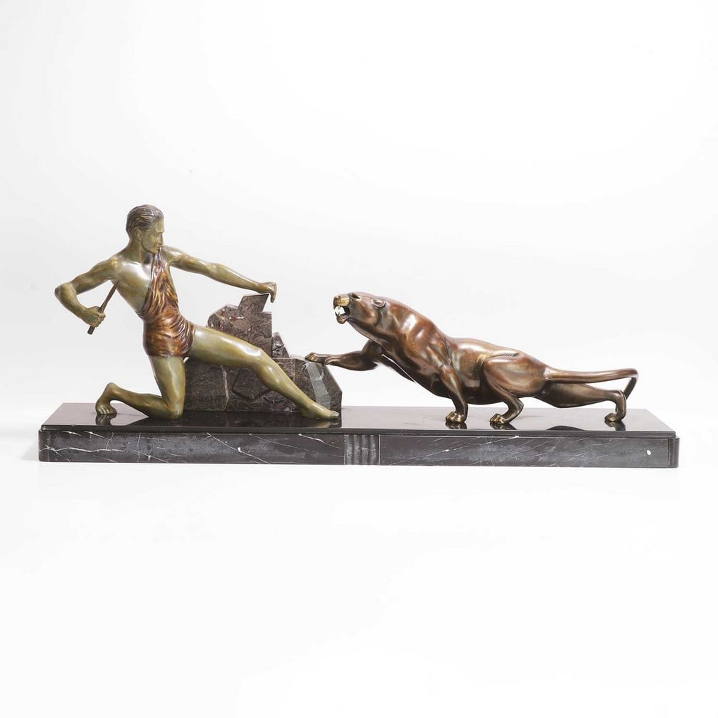 J... Brault (French, 20th century) A bronze and patinated group: J... Brault (French, 20th century) A bronze and patinated group French, depicting a man and a panther, signed 'Brault' to the panther's foot, mounted on a marble plinth (85cm wide, 18.5cm deep,&#