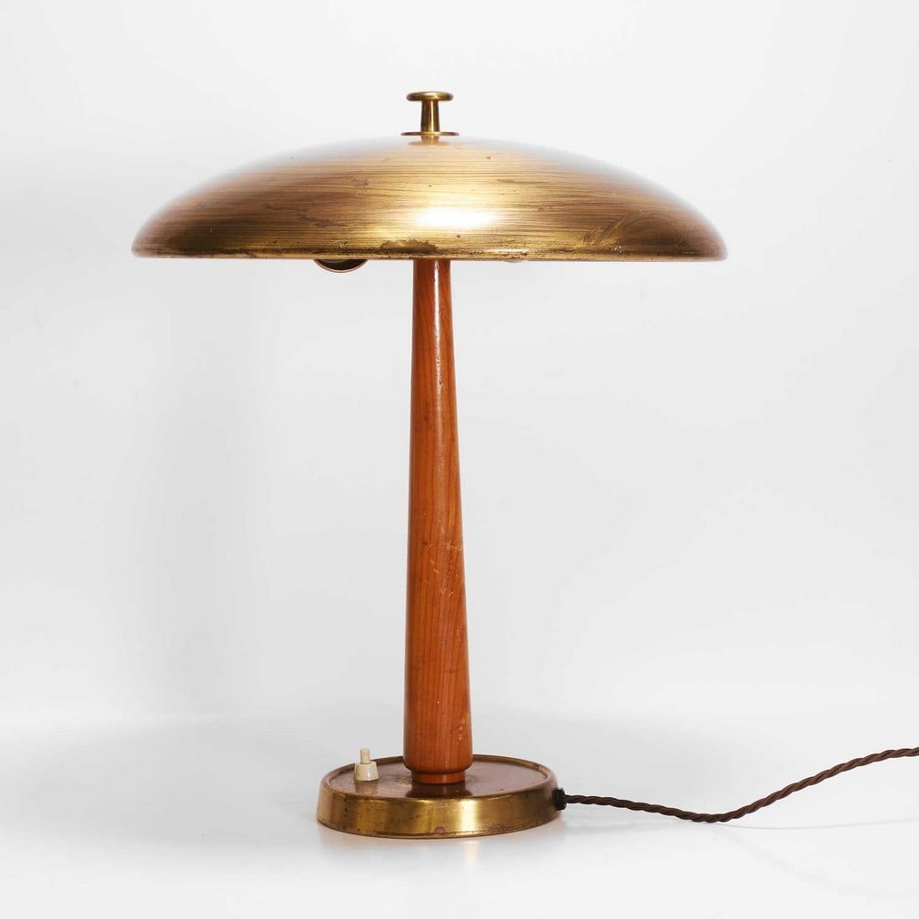 Bertil Brisborg (Swedish, 1910-1993) for Nordiska Kompaniet A model '30331' table lamp: Bertil Brisborg (Swedish, 1910-1993) for Nordiska Kompaniet A model '30331' table lamp c.1940-50, Swedish, the matte finished brass domed shade over a tapering elm stem, raised on matte finished