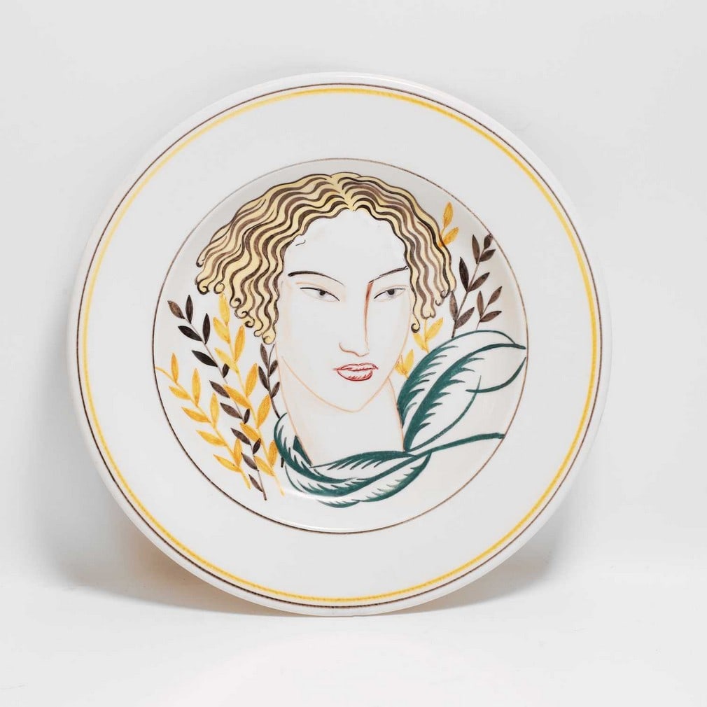 Olive Bourne for Poole Pottery A painted dish: Olive Bourne for Poole Pottery A painted dish Originally designed in 1926-1927 / c.1950s, pattern X/GZ, painted with a stylised portrait of a woman, printed and painted marks (28cm diameter)