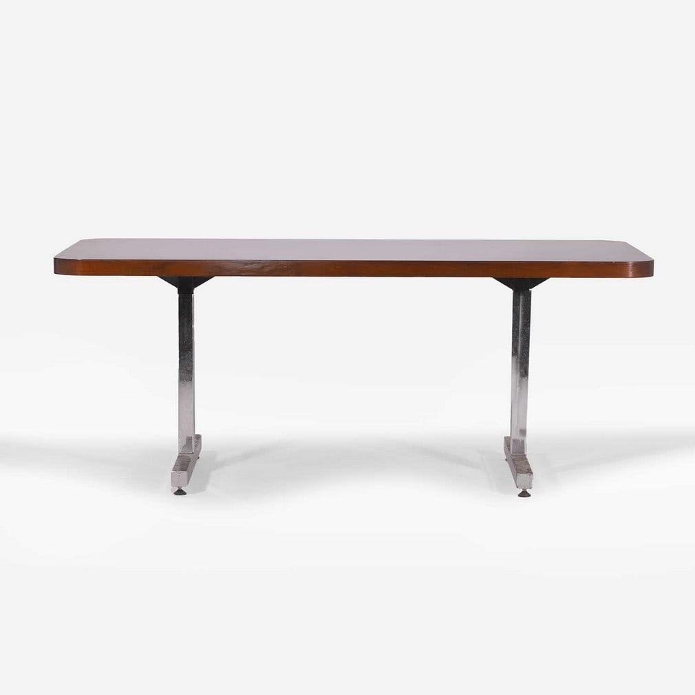 § A rosewood table 1970s: § A rosewood table 1970s With a rectangular top with rounded corners, raised on a pair of 'T' bar chrome stands CITES Article 10 Certificate Number: 25GBA10G5162P CITES - Important Information: T