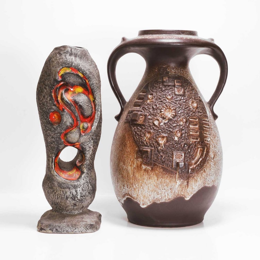 Walter Gerhards (German, 1957-2000) Two 'Fat Lava' vases: Walter Gerhards (German, 1957-2000) Two 'Fat Lava' vases Comprising a German pottery twin-handled vase, 1960s, with moulded designs, with a mottled two-tone glaze, moulded mark 'WG' and numbered, and