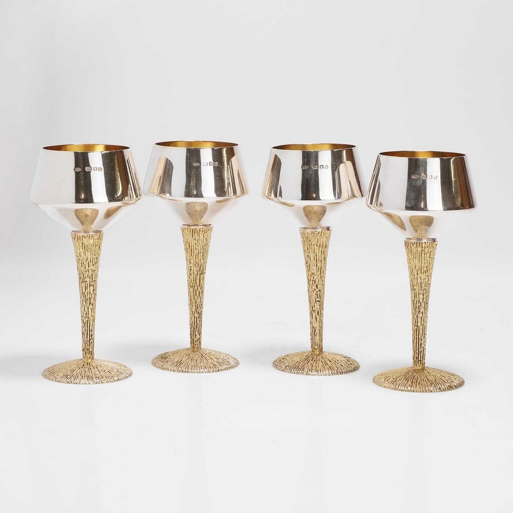 ▲ Stuart Devlin (Australian-British, 1931-2018) A set of four silver and silver-gilt goblets: ▲ Stuart Devlin (Australian-British, 1931-2018) A set of four silver and silver-gilt goblets London 1970, the polished silver cups of tapering conical form with silver-gilt interiors, over textu