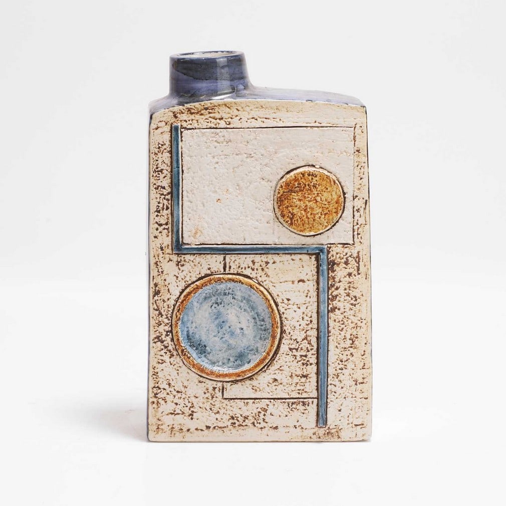 Avril Bennett for Troika Pottery A 'Chimney' vase: Avril Bennett for Troika Pottery A 'Chimney' vase Cast in low relief with geometric panels in shades of blue and buff, painted marks and artist's monogram (19.5cm high) Provenance: A private