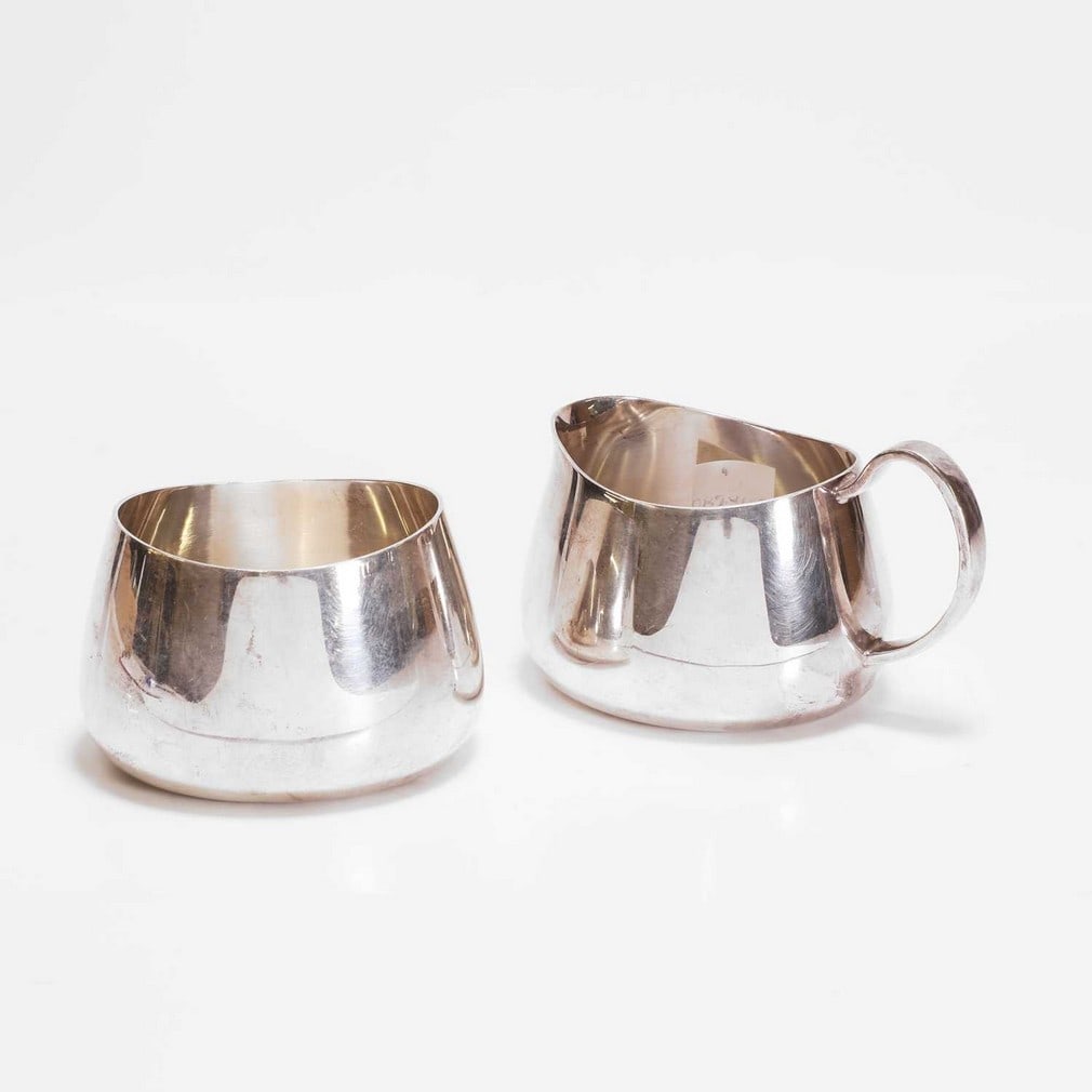 David Mellor for Walker & Hall A 'Pride' pattern sugar bowl and milk jug: David Mellor for Walker & Hall A 'Pride' pattern sugar bowl and milk jug Silver-plated, model 53722, c.1959, each piece of plain tapering form (the sugar bowl 6.5cm high, 10cm wide, 8cm deep, the
