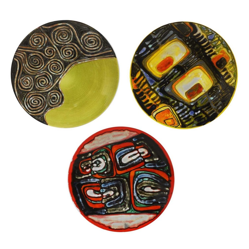 Poole Pottery Three 'Delphis' chargers: Poole Pottery Three 'Delphis' chargers Shape no.5, one carved and painted, printed and painted artists' marks (each 36.5cm diameter) (3) Provenance: A private collection, Norfolk. Condition Report: Go