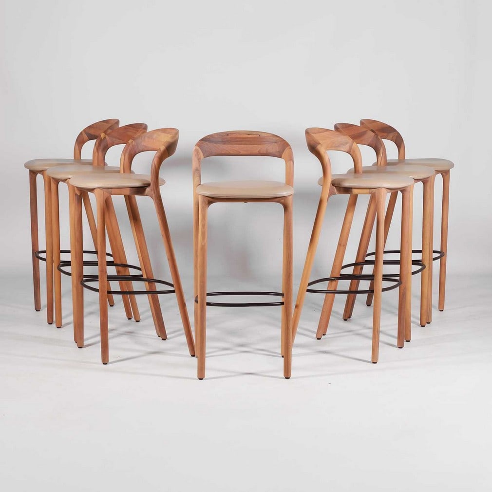 Artisan A set of seven 'Neva' bar stools: Artisan A set of seven 'Neva' bar stools Of recent manufacture, the oak ribbon backs, with taupe grained leather seats, raised on four legs united by a black painted metal foot rest, each with