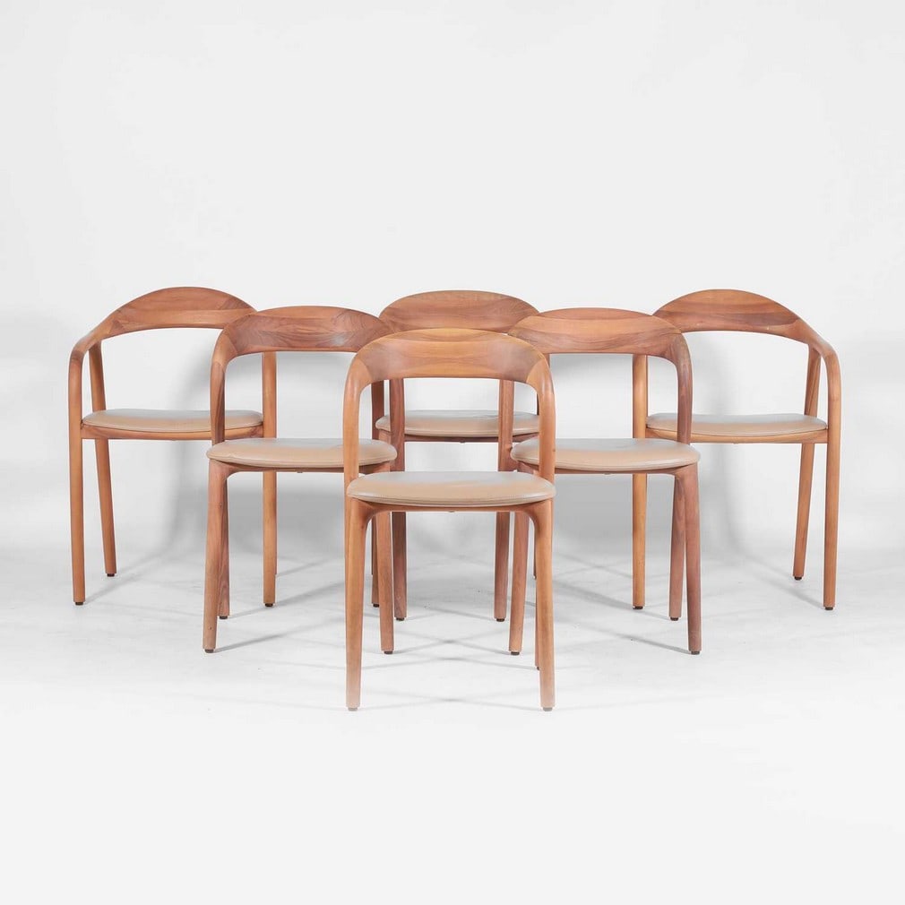 Artisan A set of six 'Neva' dining chairs: Artisan A set of six 'Neva' dining chairs Of recent manufacture, the oak frame with leather upholstery, two examples with arms, each with applied manufacturer's label (53cm wide, 50cm deep, 79cm high,