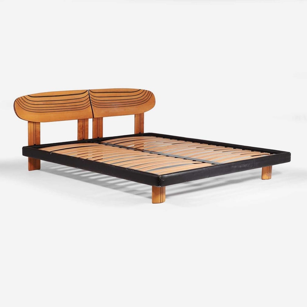 Manner of Afra and Tobia Scarpa A walnut double bed: Manner of Afra and Tobia Scarpa A walnut double bed Late 20th century, the laminated rounded headboard raised on four rounded supports, with two further matching feet at the foot of the bed, with a