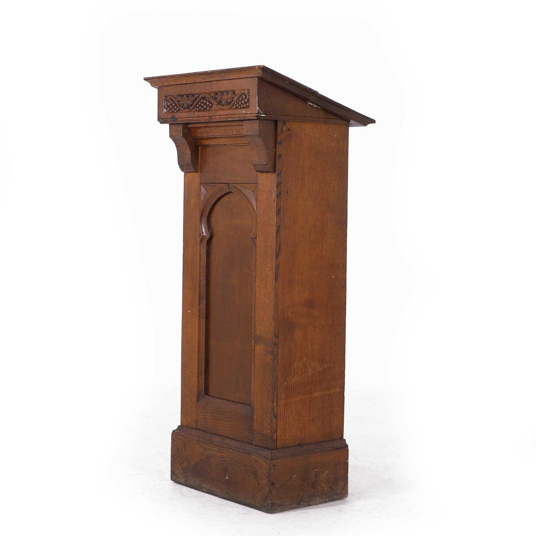A Victorian oak lectern,: A Victorian oak lectern, with painted graining embellishments and a frieze carved with fruiting grapes over a panelled front,64cm wide52cm deep141cm high Condition Report: Half the slope is loose and