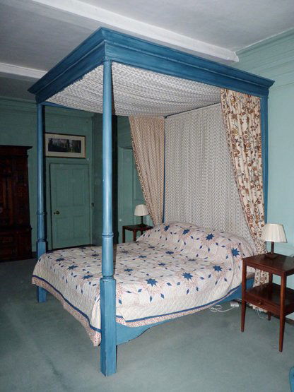 A four-poster bed, (SH) by Peter Harbern of Bath, pai: A four-poster bed, (SH) by Peter Harbern of Bath, painted blue with floral drapes, 261cm high 186cm wide