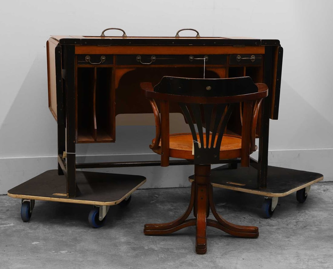 An architect’s desk Of recent manufacture: An architect’s desk Of recent manufacture Labelled ‘per mare – per terram, AM, by land & by sea’, with a hinged and drop leaf top, together with a conforming desk chair,wi