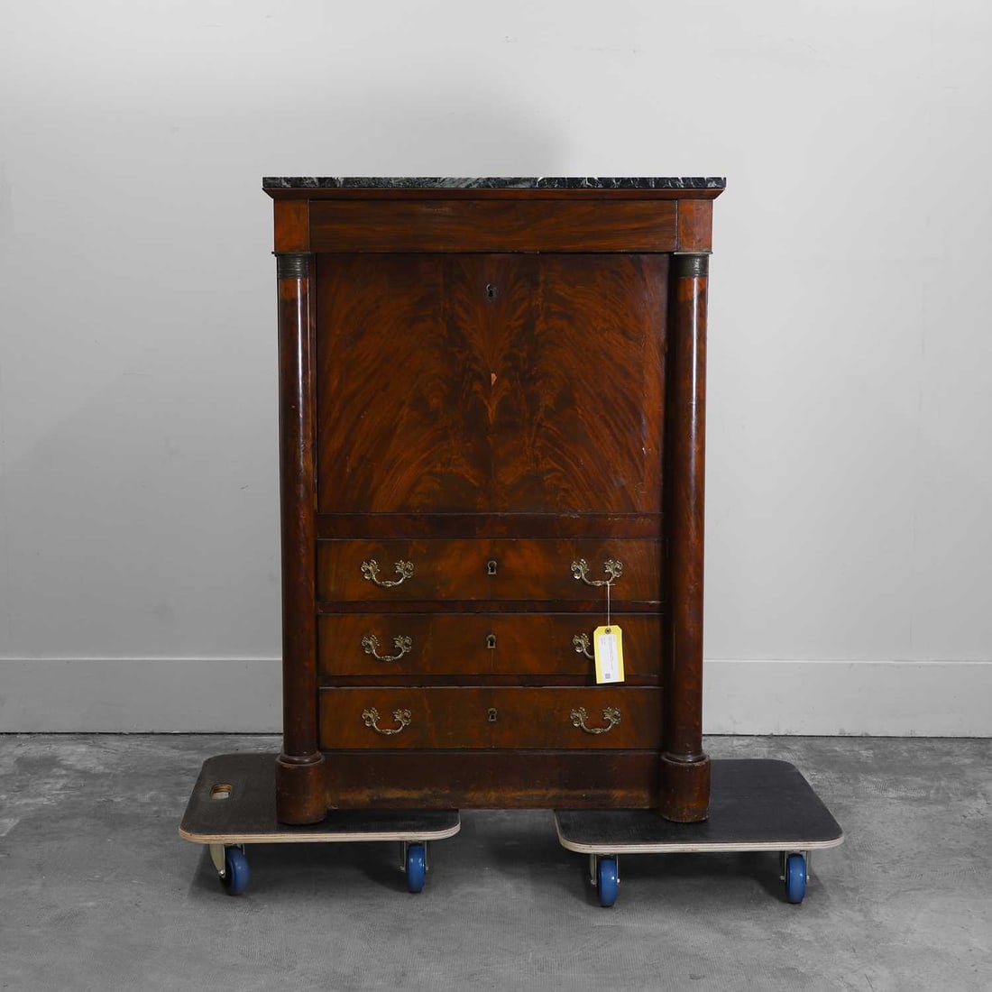 A French Empire mahogany escritoire 19th century: A French Empire mahogany escritoire 19th century With a marble top and fitted interior, with an arrangement of three long drawers 92cm wide, 133cm high Condition Report: The columns are both