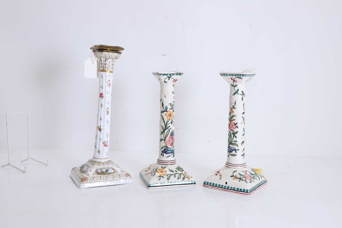 A pair of floral decorated ceramic candlesticks Second half of the 20th century: A pair of floral decorated ceramic candlesticks Second half of the 20th century By Outeiro Agueda, decorated with scrolling vines and flowers stamped and painted marks to the base, together with anot