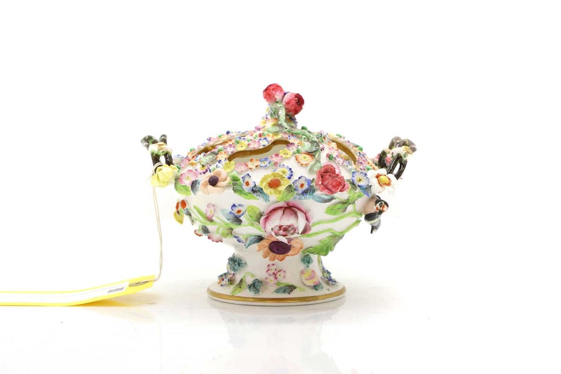 A Spode floral encrusted potpourri bowl and cover 19th century: A Spode floral encrusted potpourri bowl and cover 19th century With a rose bud finial, and mottled twin twisted side handles, with high relief floral decoration, painted mark to the base 19.2cm wide,