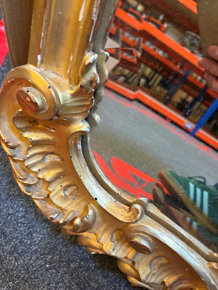 A gilt framed wall mirror, - 12