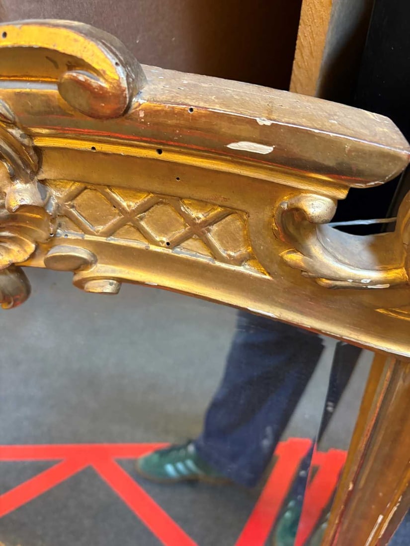 A gilt framed wall mirror, - 17