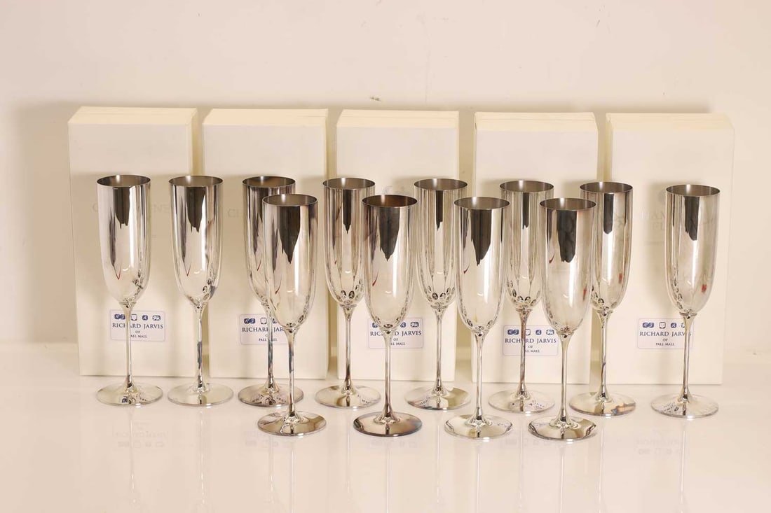 A collection of twelve silver champagne flutes: A collection of twelve silver champagne flutes By Robbe & Berking, Birmingham, late 20th century, marked 925, retailed by Richard Jarvis of Pall Mall 24cm high, 91.1ozt 12 Condition Report: