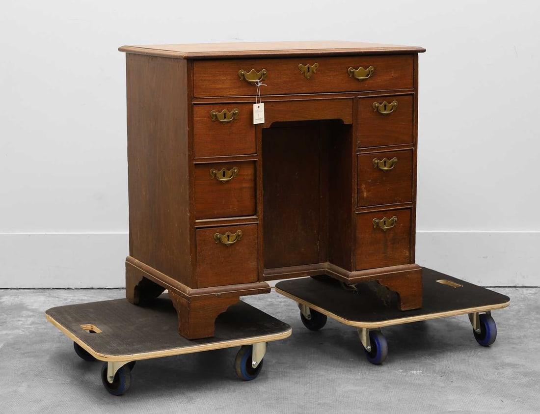 A George III mahogany kneehole desk 19th century: A George III mahogany kneehole desk 19th century With an arrangement of six short drawers below one long drawers, all with brass swan neck handles, on bracket feet 77cm wide, 53cm deep, 79cm