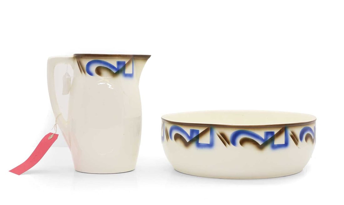 A Meissen 'Hans' pottery jug and basin 20th century: A Meissen 'Hans' pottery jug and basin 20th century With airbrushed blue and brown bands, moulded and printed marks 25cm high, 34cm diameter 2 Condition Report: Frit marks to the edge of the