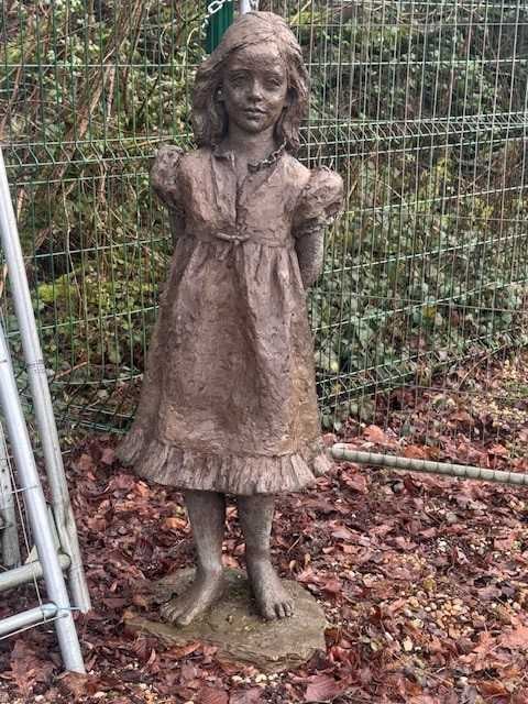 Marion Smith (20th century) 20th century: Marion Smith (20th century) 20th century A bronzed figure of a young girl, her hands behind her back, on a round naturalistic base 46cm wide, 40cm deep, 135cm high Condition Report: Fair,