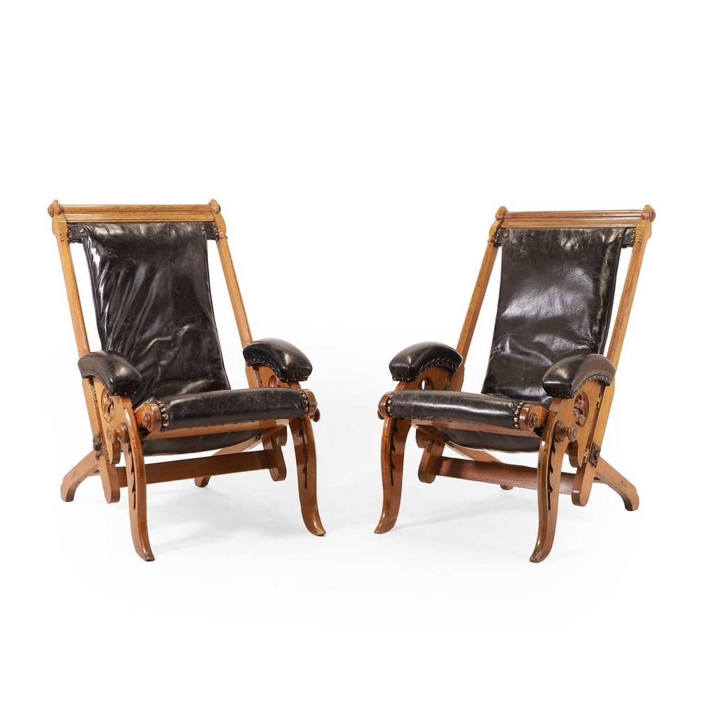 Attributed to James Herbert McNair (1868-1955), a pair of Gothic Revival oak folding library chairs, (1 of 3)