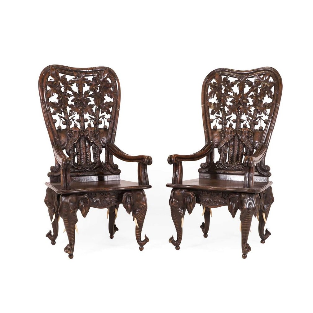 A pair of carved linden wood Black Forest elbow chairs, c.1900, Swiss, attributed to Peter Trauffer (1 of 4)