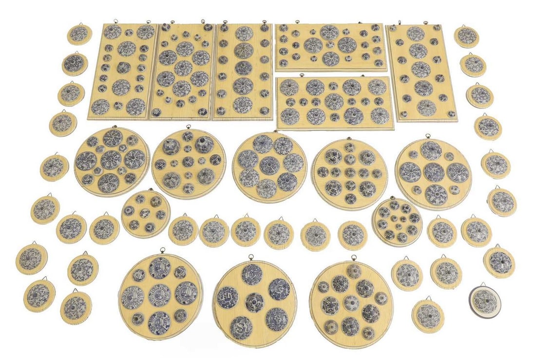 A collection of blue and white Vung Tau Cargo porcelain lids, 17th century, later mounted by Alberto: A collection of blue and white Vung Tau Cargo porcelain lids, 17th century, later mounted by Alberto Pinto, c.1992, consisting of Chinese Kangxi blue and white porcelain pot covers arranged on painted