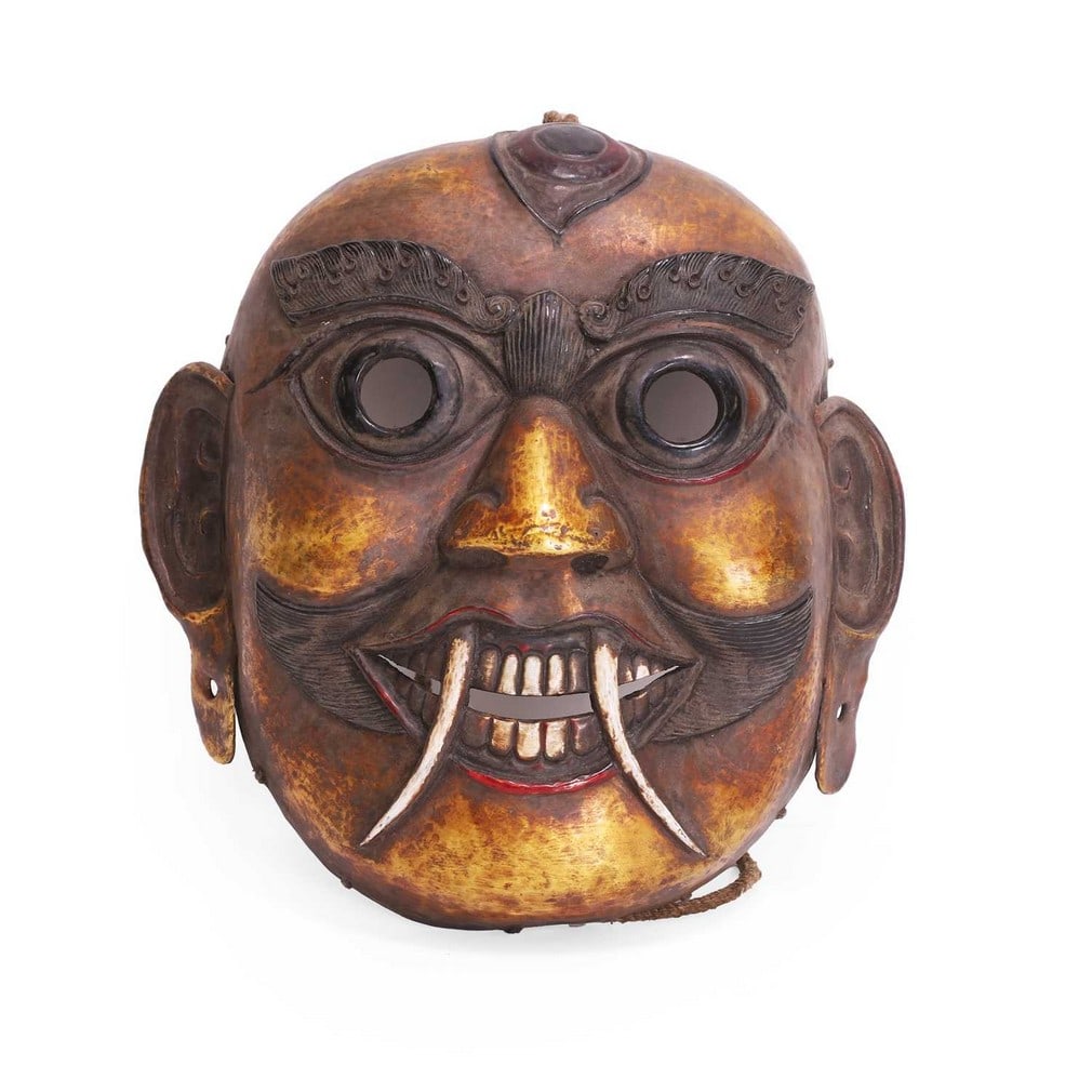 A Tantric Buddhist gilt-bronze repoussé mask, late 19th/early 20th century, Tibetan, (1 of 2)