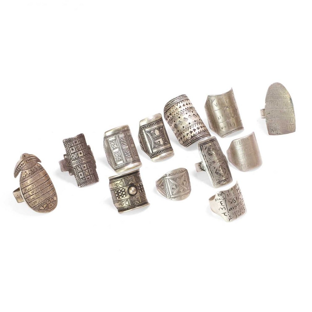 Twelve Tuareg white-metal rings, 19th-20th century, Niger,: Twelve Tuareg white-metal rings, 19th-20th century, Niger, each with engraved decoration, five inscribed with Islamic script (largest 4.2cm long) (12) Provenance: The Romy Rey Collection, London.