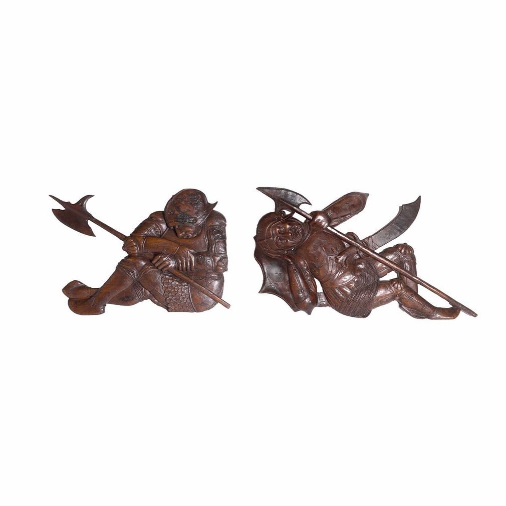 A pair of carved walnut recumbent soldiers, 16th-17th century, Continental,: A pair of carved walnut recumbent soldiers, 16th-17th century, Continental, from a Gethsemane scene, each depicted sleeping whilst wearing armour and holding a halberd (84cm wide, 44.5cm high and 66cm