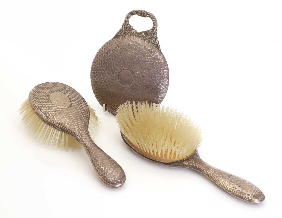 A matched silver-backed dressing mirror and a pair of brushes, - 2