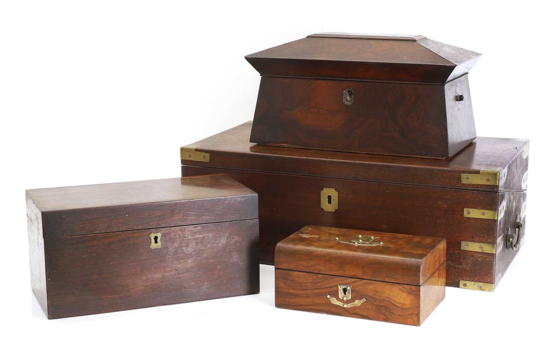 A large mahogany writing slope, Late 19th century and later: A large mahogany writing slope, Late 19th century and later The inside opening to reveal red velvetine writing surface with brass mounts to the outside, a rosewood sarcophagus-shaped tea caddy, with