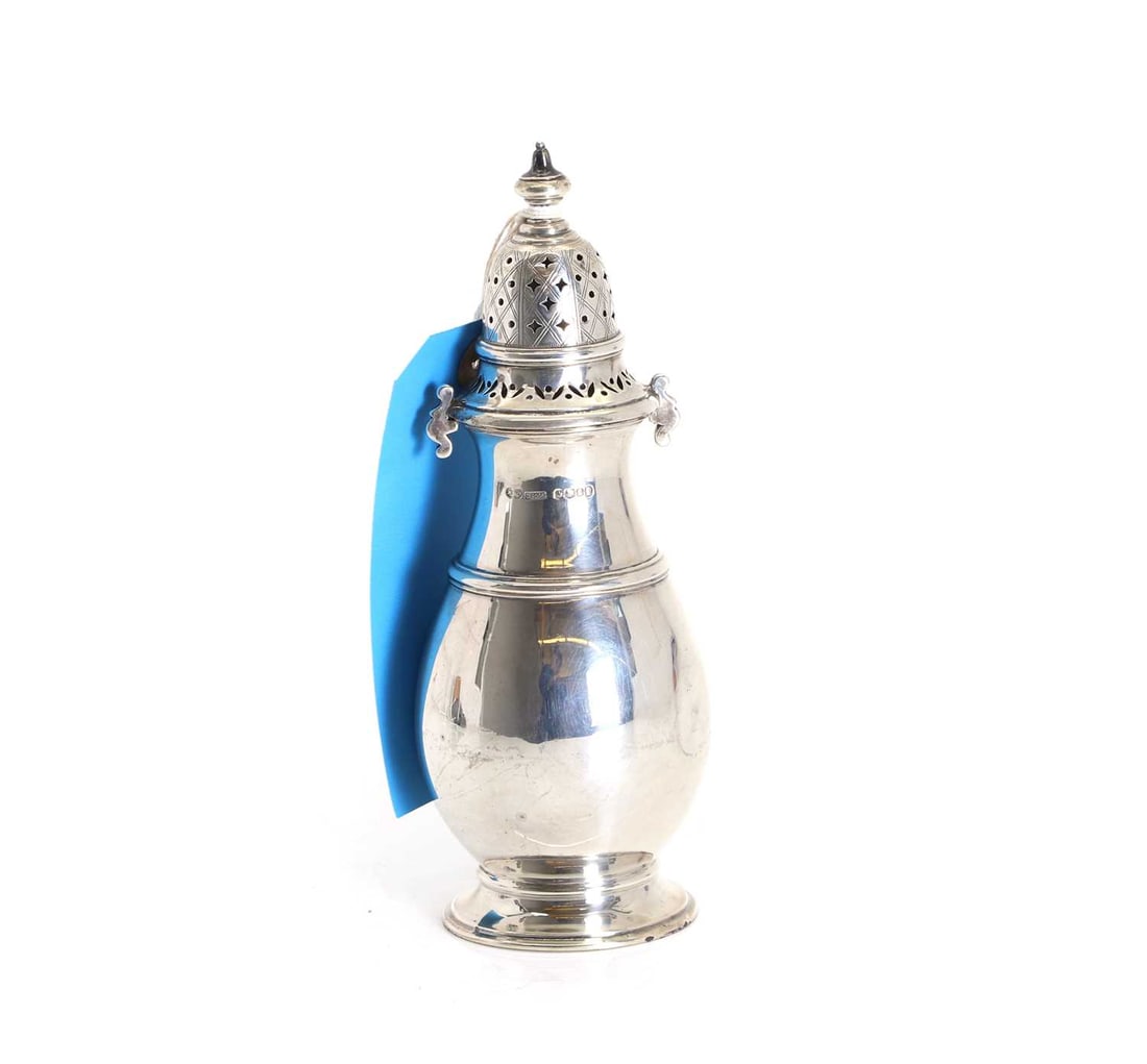 A silver sugar sifter,: A silver sugar sifter, By Joseph Rodgers & Sons, Sheffield, 1960, with pierced decoration to the top lid 19cm high, 6.39 ozt