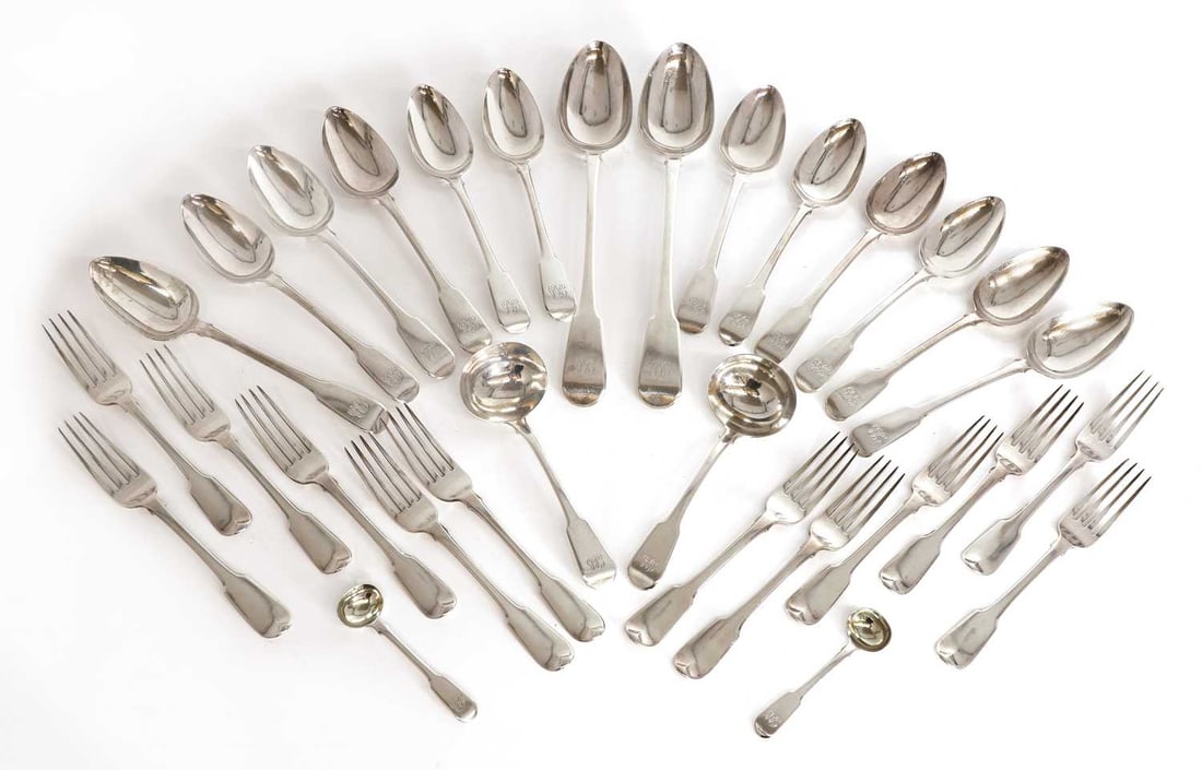 Twelve silver fiddle pattern table spoons and twelve fiddle pattern table forks by William Eley, Wil: Twelve silver fiddle pattern table spoons and twelve fiddle pattern table forks by William Eley, William Fearn and William Chawner, London, 1812 each monogramed, and a pair of sauce ladles, a pair of