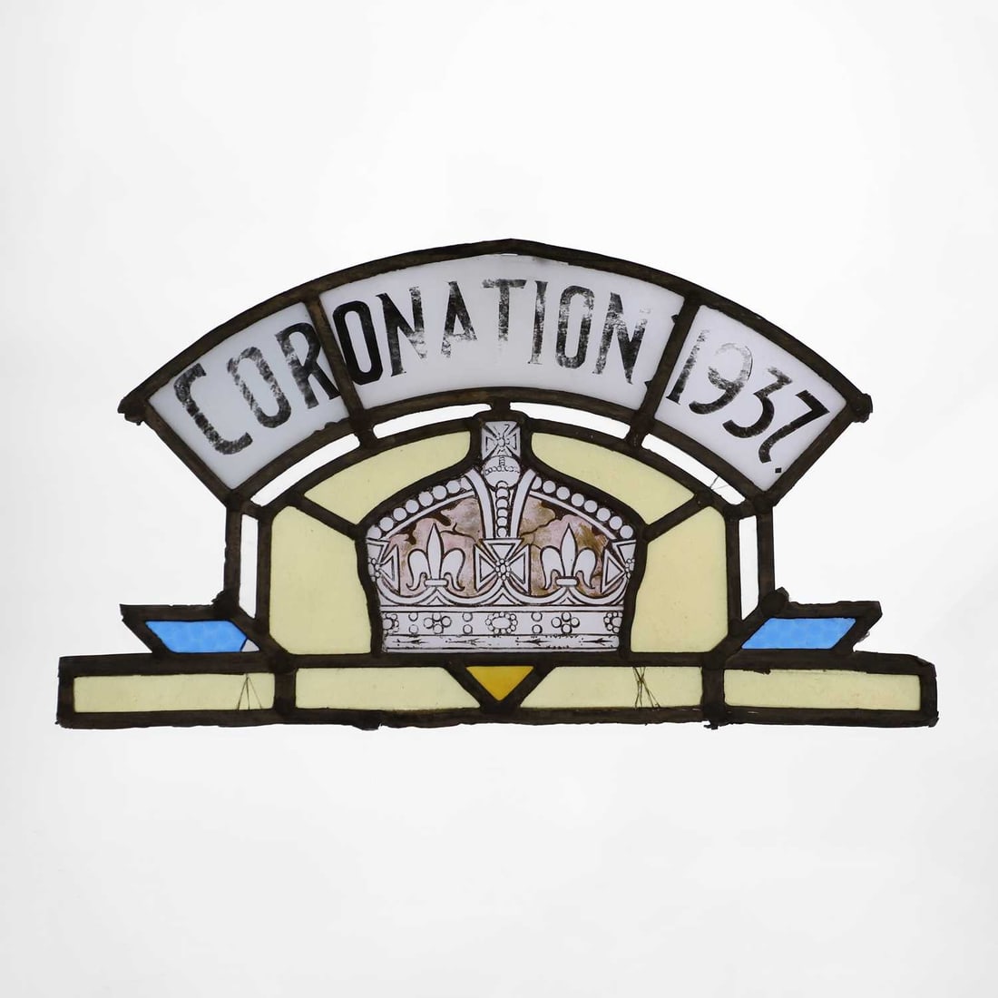 A lead glass commemorative 'Coronation 1937' panel, 20th century: A lead glass commemorative 'Coronation 1937' panel, 20th century of arched form, centred with a crown, with clear, amber and blue glass panels 52cm wide 30cm highCondition Report: The glass panels wi