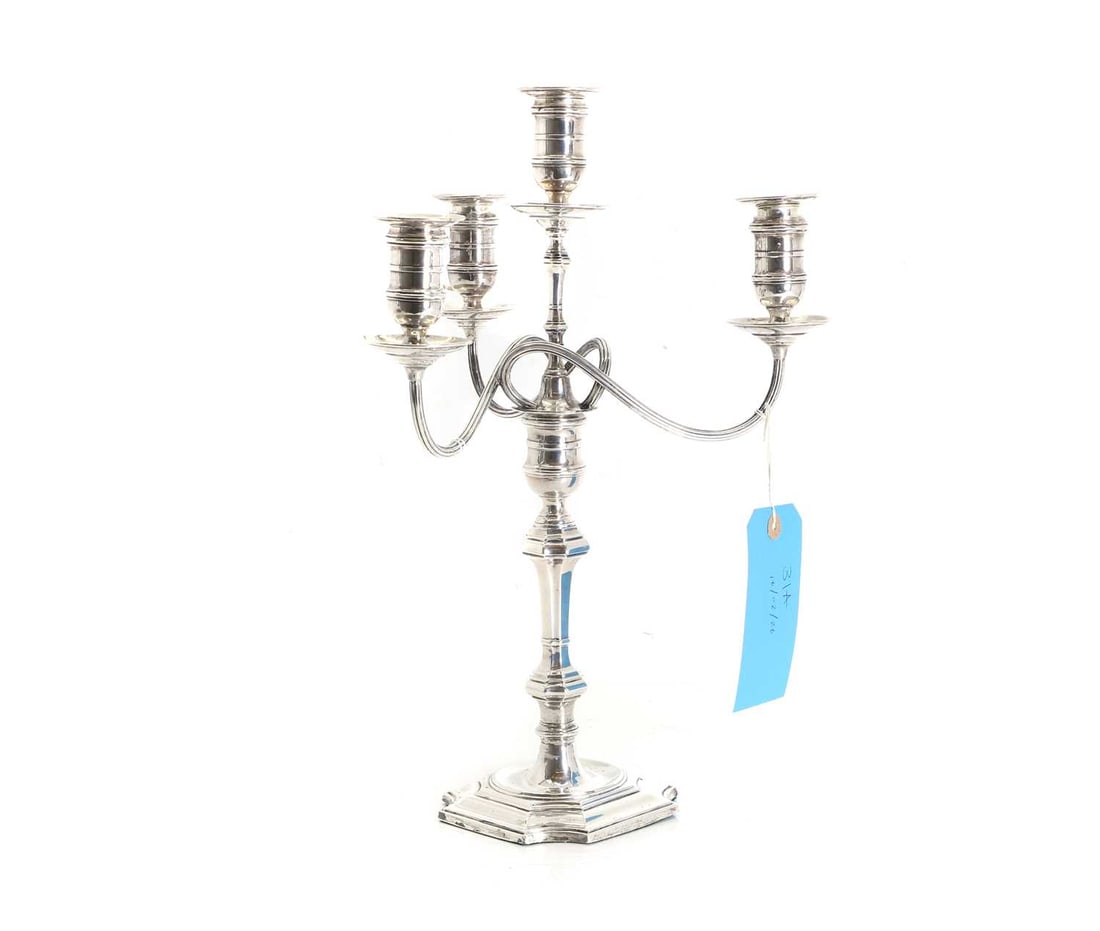 A silver candelabra,: A silver candelabra, Birmingham, 1944, with three scroll branches with twisted design, with shaped coloumn, filled 43cm high, removed top section 23.33ozt