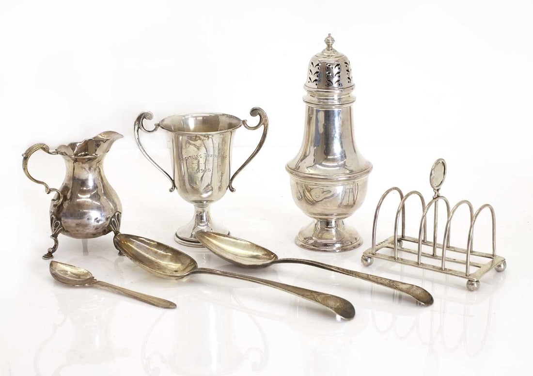A collection of silver items,: A collection of silver items, A silver sugar caster, Birmingham, 1957, small silver trophy, 'Brightling Tournament, 1928', a Victorian silver four division toast rack, two Georgian silver and bright