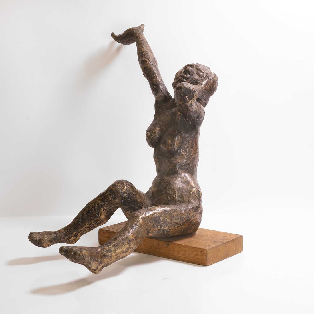 Richard Robbins (1927-2009),: Richard Robbins (1927-2009), a seated lady, bronze, on an oak plinth, 46cm wide 45cm deep 52cm high