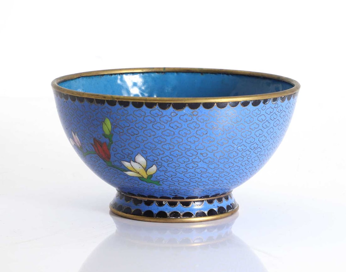 A Chinese cloisonne bowl, Late 20th century,: A Chinese cloisonne bowl, Late 20th century, With blue ground decorated with scrolling clouds and blossoms 15.2cm diameter, 8cm high Condition Report: Some minor marks to the rims. Some very minor
