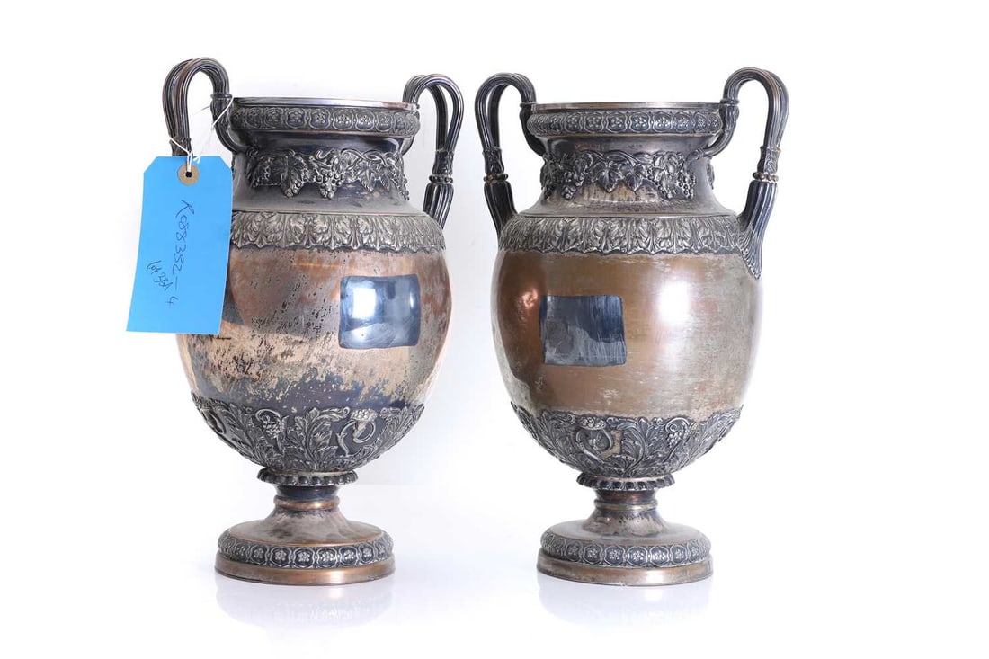 A pair of Sheffield-plated wine coolers, 19th century,: A pair of Sheffield-plated wine coolers, 19th century, with twin handles, vine and acanthus banding, worn 21cm wide, 18cm deep, 34.5cm high 2 Condition Report: Rubbed and loss to the plate.